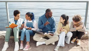 Instructor with students sitting outside.