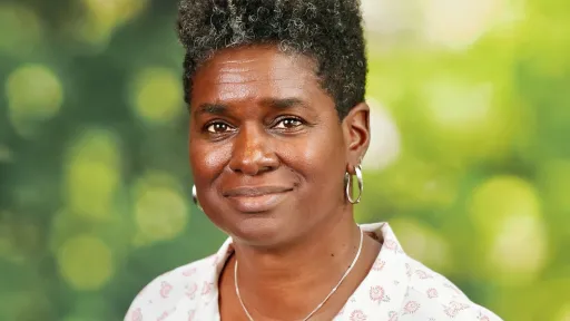 Woman with short gray hair, smiling.