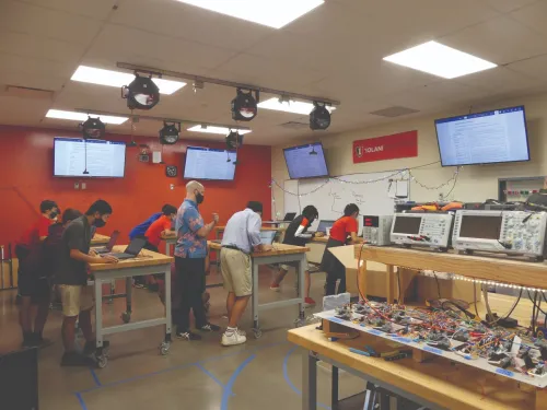 Electronics lab with students working.
