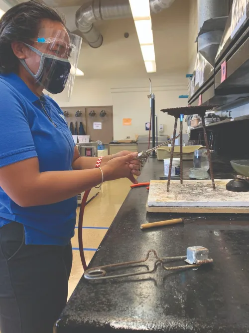 Jacob Pacarro, assistant principal at Kamehameha Schools Kapālama, works in a workshop.