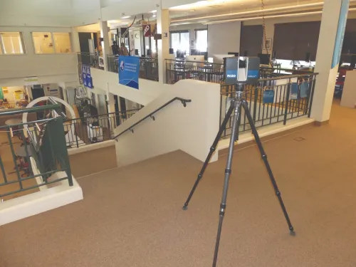 A camera is mounted on a tripod at the top of a flight of stairs.