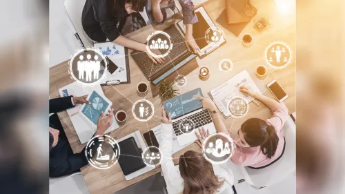 Overhead photo of businesspeople at table with graphics overlay.