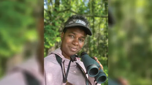 Woman in nature with binoculars.
